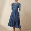 Blue embroidered A-line midi dress with sheer sleeves and pockets by FJØRNA, stylish and elegant for casual or formal wear.