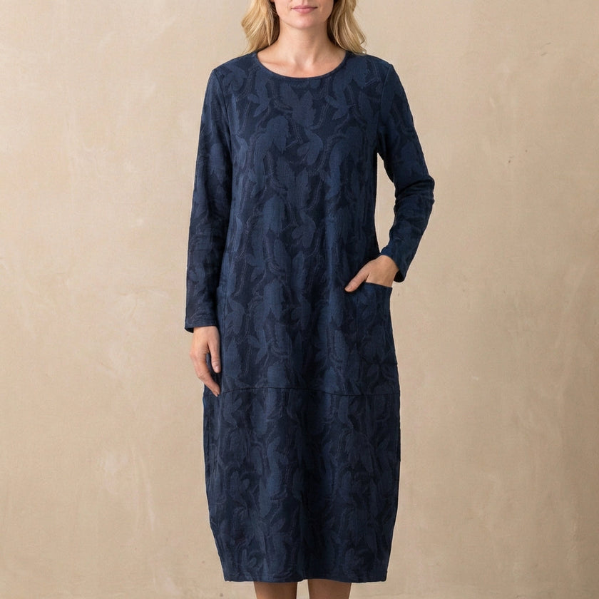 Blue FJØRNA relaxed knit maxi dress with textured pattern and patch pockets, flowing and comfortable for casual wear.