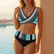 Blue FJØRNA bikini top with wrap front, v-neck, and form-fitting cropped design, perfect for swimwear and beachwear.