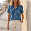 Blue FJØRNA summer blouse for women with a printed denim design, lightweight top perfect for warm weather.