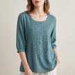 Blue floral V-neck summer blouse for women by FJØRNA, lightweight top with feminine design and short sleeves.