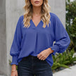 Blue FJØRNA summer women's V-neck denim blouse with ruffle trim, lightweight and stylish for warm weather.