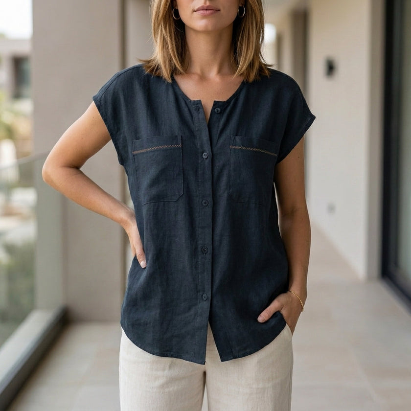 Blue V-neck sleeveless summer blouse for women by FJØRNA, featuring lightweight fabric and stylish design.