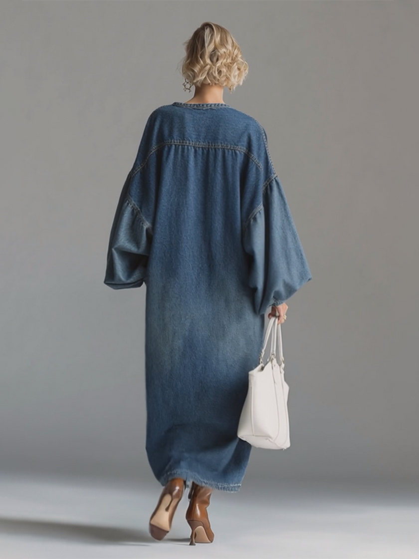 Blue denim maxi dress by FJØRNA featuring a flowing silhouette and casual-chic style, perfect for evening wear or daytime occasions.