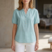 Lightweight blue denim summer blouse for women with puff sleeves and button-front design by FJØRNA.
