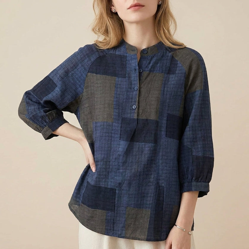 Blue FJØRNA summer blouse for women with geometric V-neck, stylish top perfect for warm-weather casual wear.