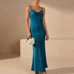 Blue FJØRNA slim fit sleeveless maxi dress with cowl neck, flowing fabric and elegant design for evening or summer wear.
