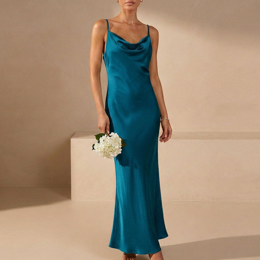 Blue FJØRNA slim fit sleeveless maxi dress with cowl neck, flowing fabric and elegant design for evening or summer wear.