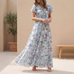 Blue FJØRNA A-Line maxi dress with V-neck and flutter sleeves, flowing and elegant for casual or formal occasions.