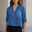 Blue floral V-neck denim blouse for women by FJØRNA, stylish summer top with lightweight fabric and casual fit.