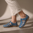 Blue FJØRNA orthopedic closed-toe sandals with cutout details and ergonomic design for comfort and support.