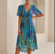 FJØRNA Sofia Amoretti flowing blue chiffon wrap midi dress with tie waist, elegant evening dress with long sleeves and lightweight fabric.