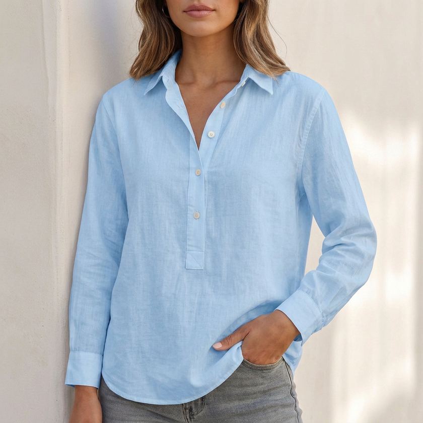 Blue FJØRNA women's V-neck popover shirt with cuffed sleeves, relaxed fit, and casual style.