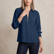 Blue FJØRNA summer blouse for women with long sleeves and smocked details, stylish and comfortable women's top.