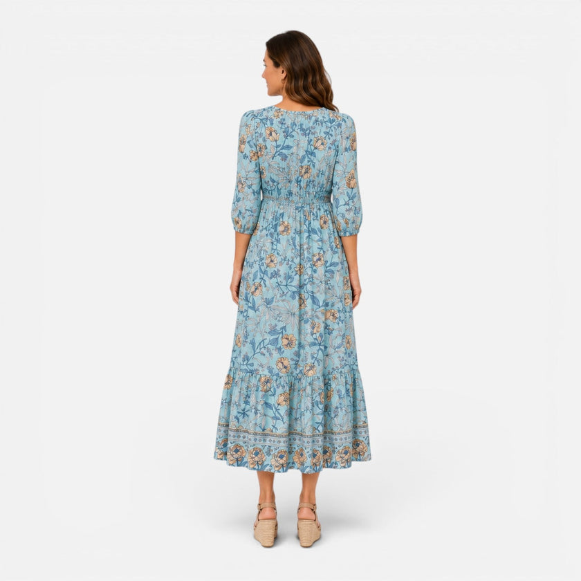 FJØRNA women's floral midi dress for summer casual wear, featuring a vibrant floral pattern and flowing fabric.