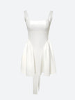 White FJØRNA bow waist backless mini dress displayed on a model, showcasing its stylish backless design and feminine bow detail.