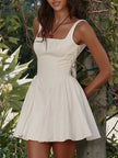 FJØRNA white bow waist backless mini dress, sleeveless design with a fitted silhouette, perfect for stylish summer occasions.
