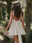 FJØRNA white bow waist backless mini dress, sleeveless design with a fitted silhouette, perfect for stylish summer occasions.