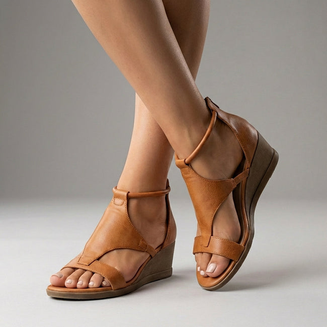 Brown FJØRNA orthopedic T-strap wedge sandals for women with cushioned insoles and ankle straps on a neutral background.