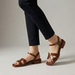 FJØRNA ankle-length flat sandals with ankle strap and buckle in brown leather, showcasing stylish and comfortable footwear.