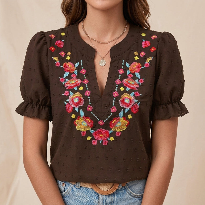 FJØRNA women's summer blouse with floral print, puff sleeves, and ruffle details in brown fabric.