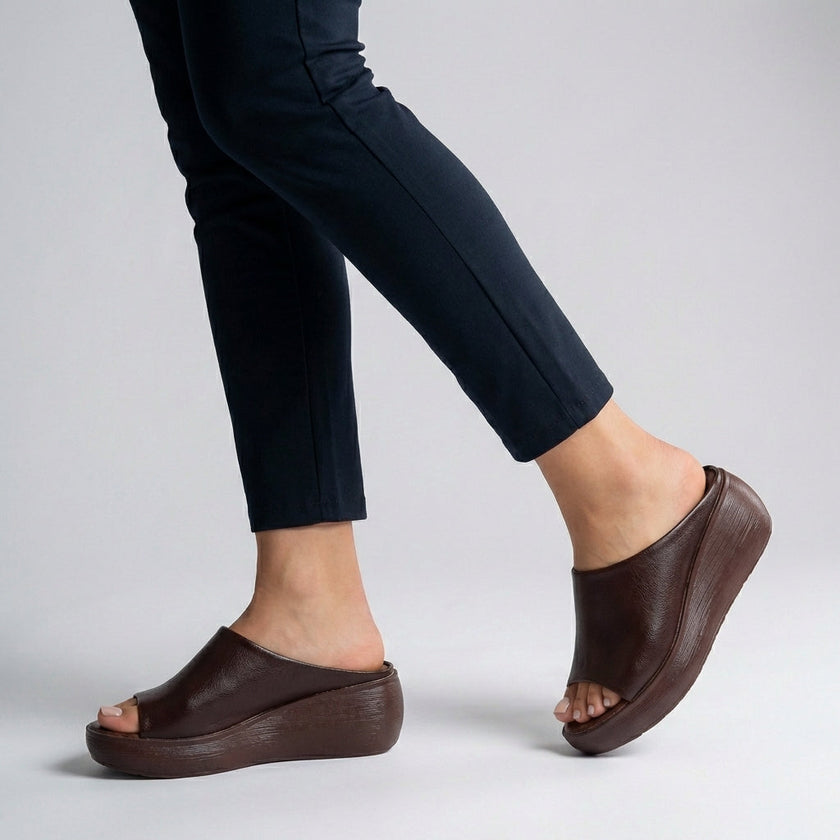FJØRNA orthopedic platform slide sandals in brown with slip-on open toe design and cushioned footbed for comfort.