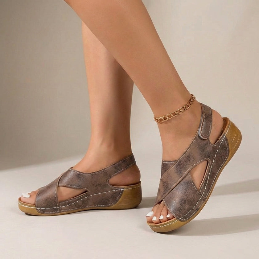 Brown FJØRNA orthopedic criss-cross slingback wedge sandals for women on a neutral background.