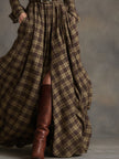 Brown FJØRNA maxi dress, casual style, flowing fabric, sleeveless design, full-length dress on a model.