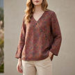 Brown FJØRNA women's summer blouse with V-neck and slit, made of lightweight linen fabric, styled as a casual top.