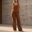 FJØRNA relaxed sleeveless two-piece set with decorative buttons and wide-leg trousers in brown fabric.