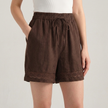 Brown FJØRNA elegant mini dress for women with drawstring linen design, featuring a stylish, relaxed fit perfect for warm weather.