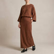 FJØRNA two-piece textured woven skirt suit with draped high-waist silhouette in brown, featuring a stylish, elegant design.