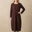 Burgundy relaxed knit maxi dress with textured pattern and patch pockets by FJØRNA, flowing and comfortable for casual wear.