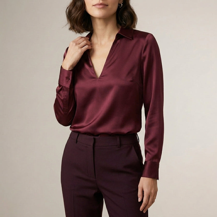 Burgundy women's satin summer blouse with V-neck, long sleeves, and high waist from FJØRNA, styled for warm weather wear.