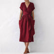 Burgundy FJØRNA elegant midi dress for women with V-neck and short sleeves, stylish and perfect for formal occasions.