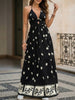 Black printed halter flowy maxi dress by FJØRNA, featuring a relaxed fit and elegant design, suitable for summer and casual occasions.