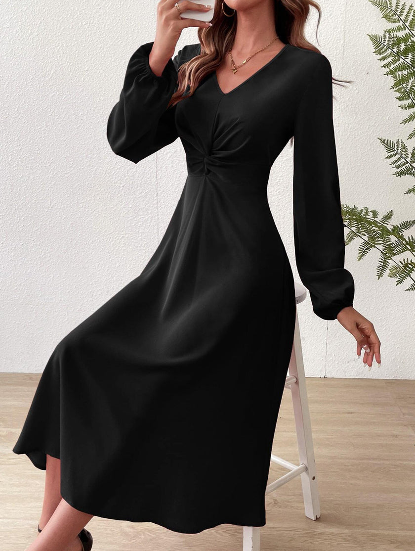 Black V-neck lantern long-sleeved dress by FJØRNA, featuring a stylish fit and elegant design, shown on a model.