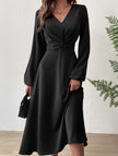 Black FJØRNA V-neck lantern long-sleeved dress with a flattering fit, showcased on a model against a neutral background.