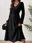 Black V-neck lantern long-sleeved dress by FJØRNA, featuring a stylish silhouette and elegant design.