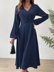 White V-neck lantern long-sleeved dress by FJØRNA, showcasing elegant fit and stylish design in a product image.