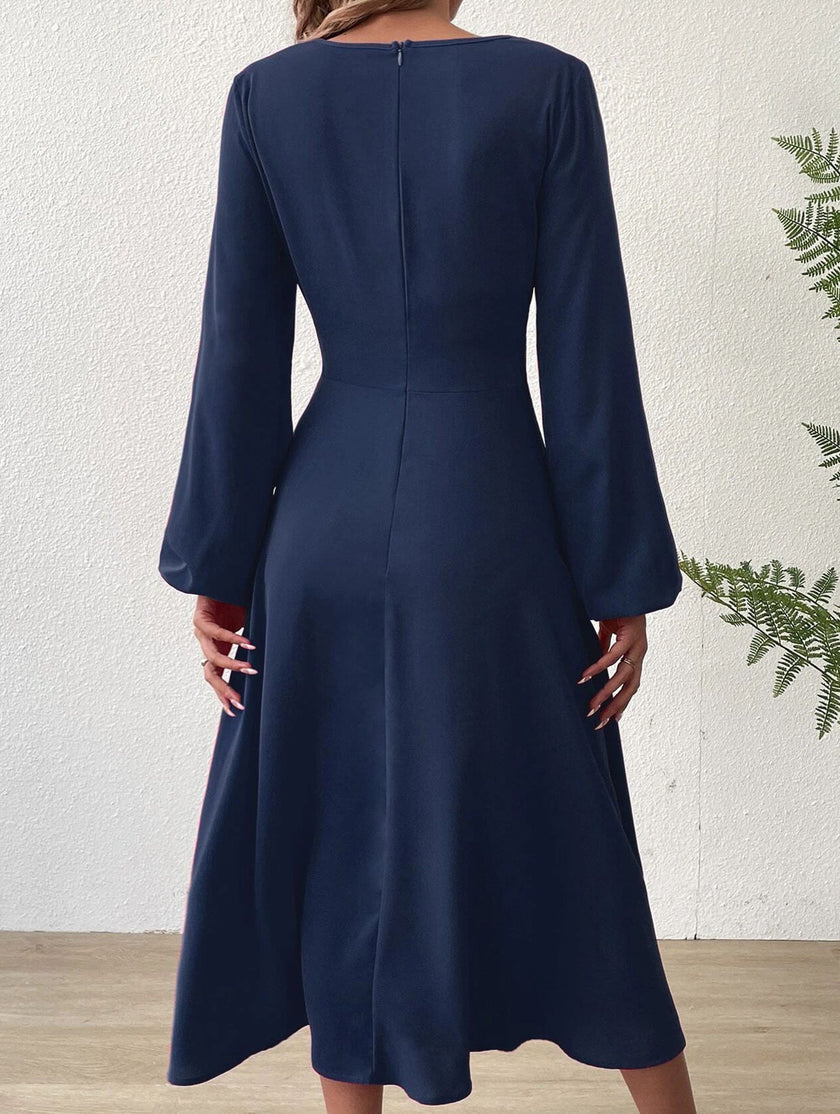 FJØRNA white V-neck lantern long-sleeved dress displayed on a hanger, showing its elegant design and flowing fabric.