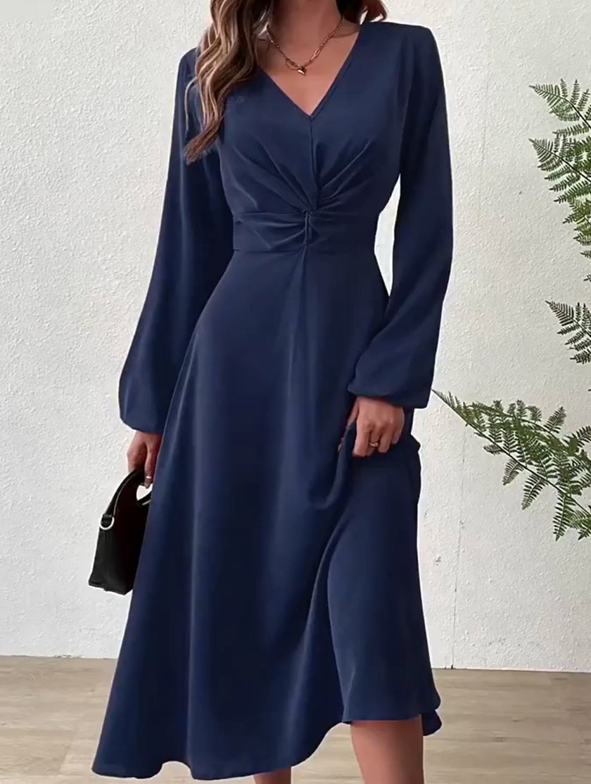 FJØRNA white V-neck lantern long-sleeved dress, stylish and elegant, shown on a model with a fitted waist and flowing skirt.
