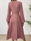 White FJØRNA V-neck lantern long-sleeved dress displayed on a hanger with a flowing silhouette and elegant design.