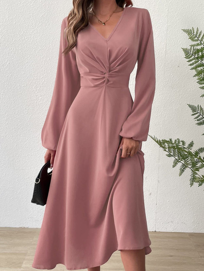 White V-neck lantern long-sleeved dress by FJØRNA, showcasing a flowing design and elegant fit, displayed on a mannequin.