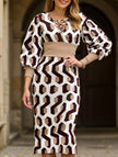White waist-hugging V-neck dress by FJØRNA, shown on a model, featuring a fitted silhouette and elegant design.