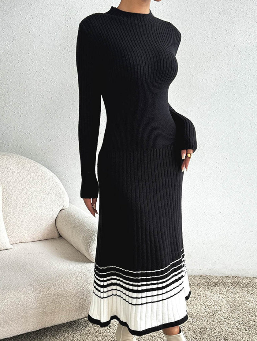 FJØRNA black and white striped pleated sweater dress featuring a stylish, knee-length design with long sleeves and a fitted silhouette.