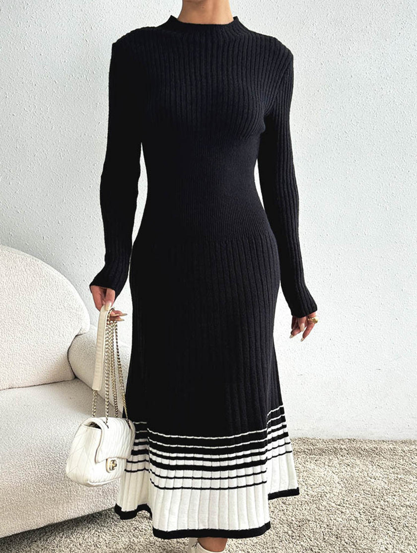 FJØRNA black and white striped pleated sweater dress, long-sleeve with a fitted silhouette, styled for casual or dressy occasions.