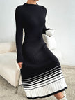 FJØRNA black and white striped pleated sweater dress, stylish and cozy, shown on a model highlighting its pattern and fit.