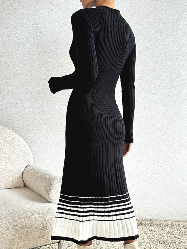 FJØRNA black and white striped pleated sweater dress, stylish and cozy, featuring a classic pattern and knee-length design.