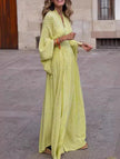 Yellow floral loose V-neck waist dress by FJØRNA, featuring a flowing design and lightweight fabric on a model.